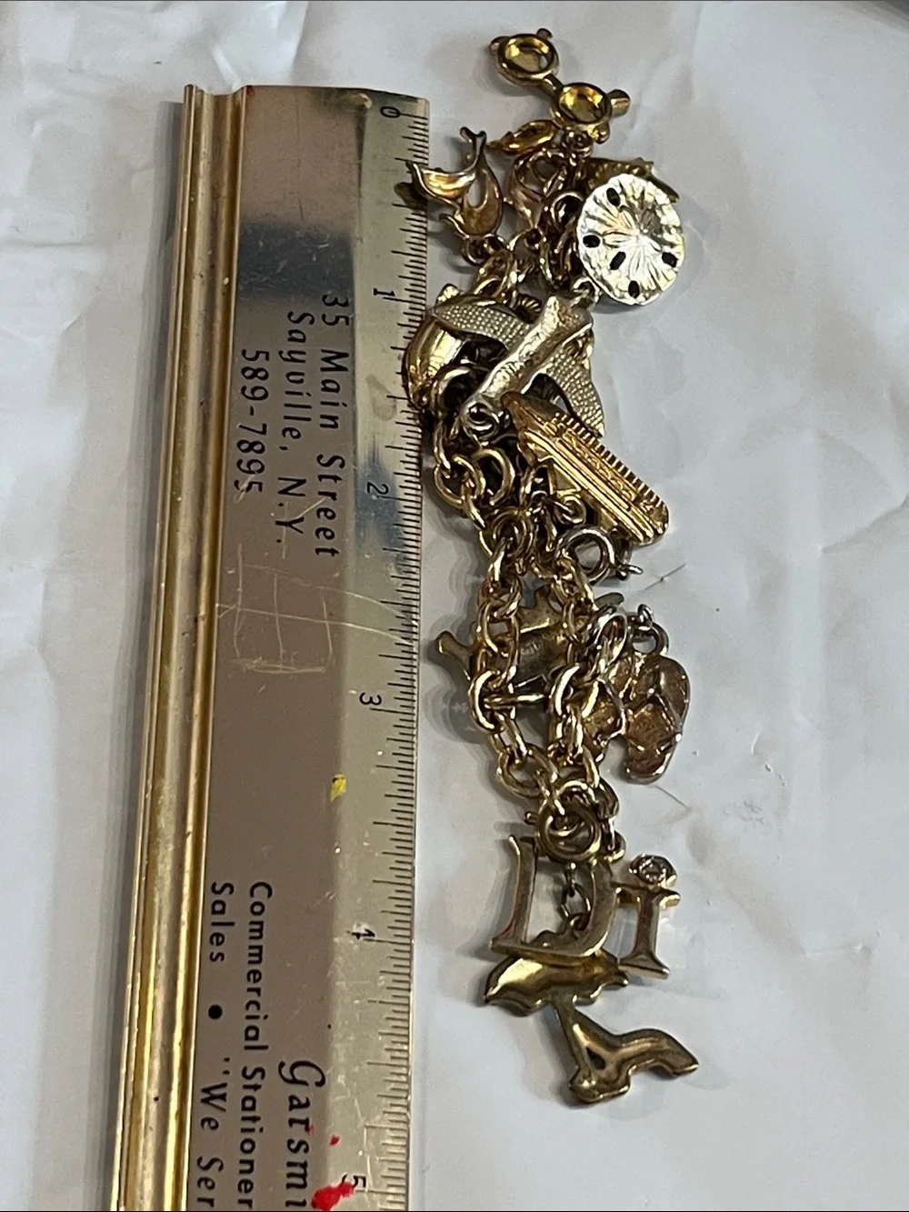 DIAMOND INTERNATIONAL GOLDTONE CHARM BRACELET